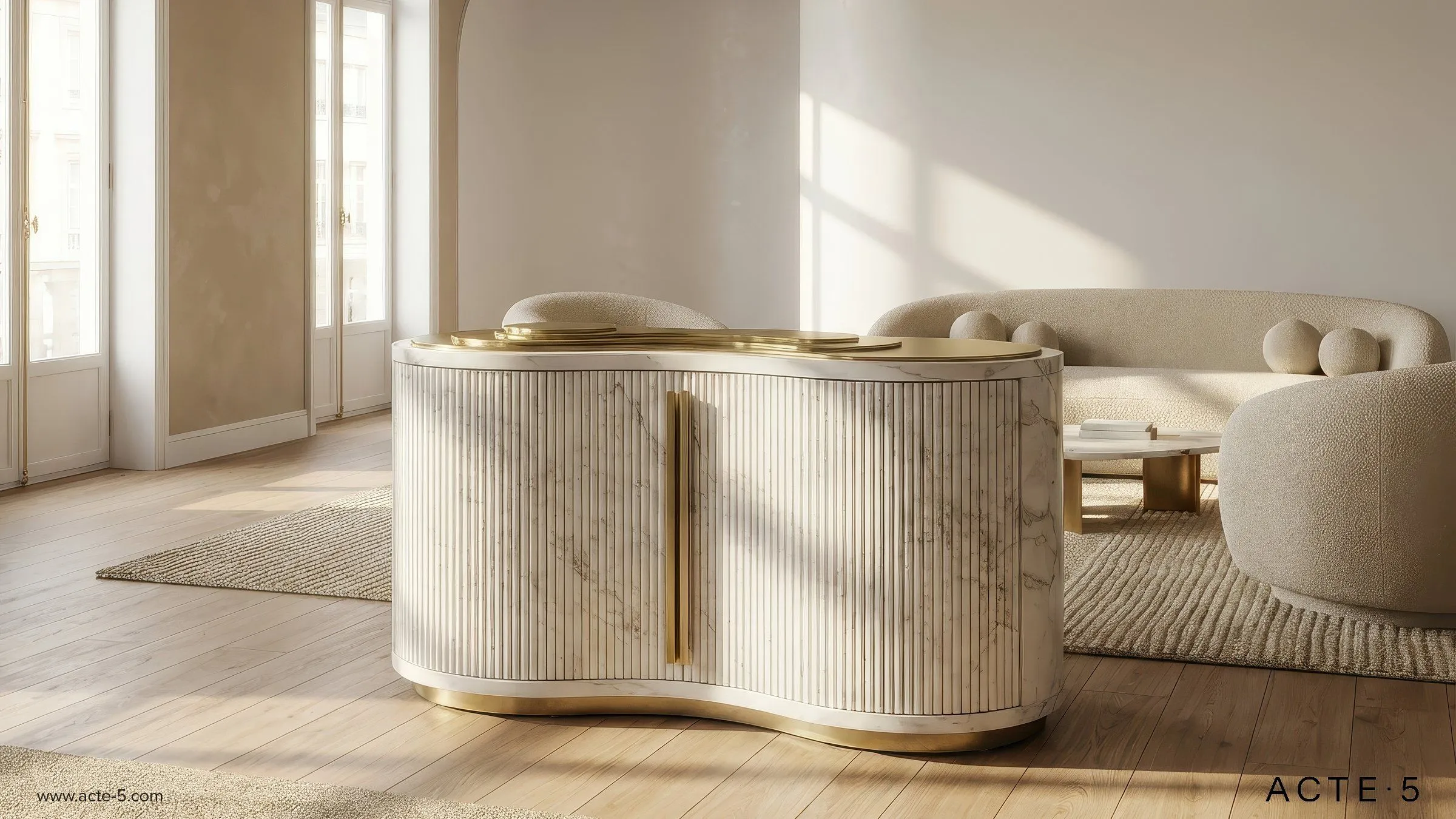 Modern interior room with large windows, a curved marble and gold accent desk, and a beige rounded sofa with textured fabric, accompanied by a small round side table and light wood flooring.